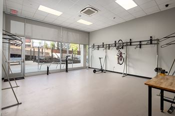 a large room with a large window and a wooden table in the middle of the room